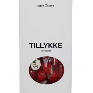 Hvid pakke med "TILLYKKE", gennemsigtigt vindue viser røde bolcher med samme tekst.